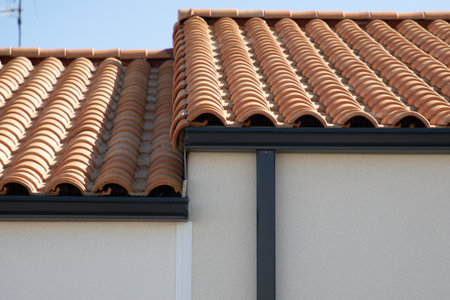 grey aluminium gutter system in new modern corner house facade