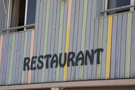 wooden facade restaurant sign on building entrance text design sign on colors background wood plankの写真素材