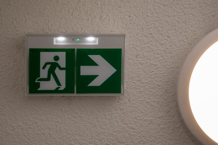 Emergency exit sign green fire exit signage showing way to escape with arrow symbol
