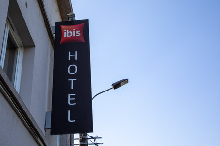 La Rochelle, France - 07 23 2024: Ibis hotel brand text red and sign facade logo on wall building entranceのeditorial素材