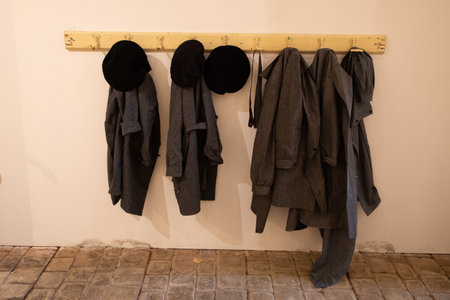 french blouses and berets hanging on the coat rack in the hallway of an old school from fifties 50sの写真素材