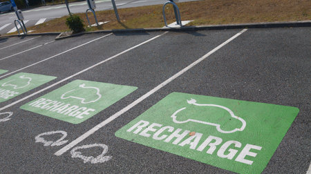 recharge e-car charging station charge point electric vehicle supply equipment with information sign car public charging plug parking spacesの写真素材
