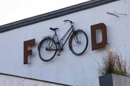 bicycle food vintage bar restaurant sign text on wall eatery pub with ancient bike in city street storefront building entranceの写真素材