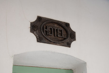 Hotel old ancient sign text in wall building facade signage on board panel wall entrance in tourist cityの写真素材