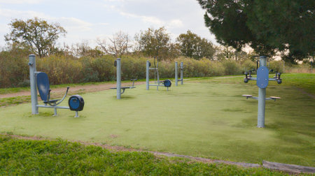 outdoor fitness park with modern exercise stations and shaded areas for workout fitness sessionsの写真素材