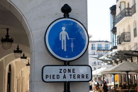 zone pied a terre french text sign means area cyclist please dismount and walk foot road signの写真素材