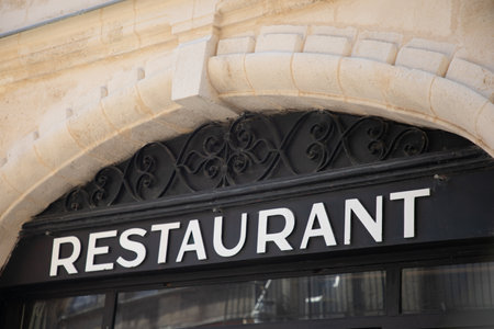 restaurant sign text board on wall facade panel in building entrance signageの写真素材