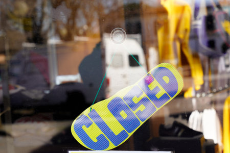 closed sign on shop door text on shoes hang on door at entrance in summer tone styleの写真素材