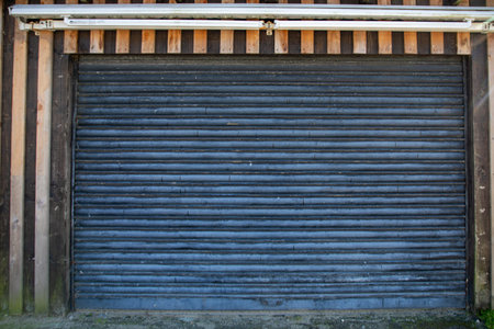 closed gray rusty roller shutter door silver abandoned entrance shop due to economic recession in...