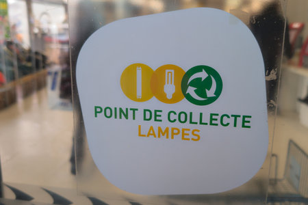 lamp collection point French text sign on display means lamp bulb collection point promotion of environmental garbage separation in public locationの写真素材