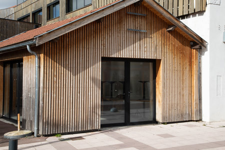 facade of a modern and new store with wooden facade in the shopping streetの写真素材