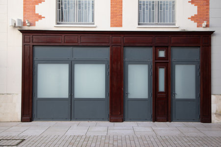 facade of a closed store transformed into a house entrance of new homeの写真素材