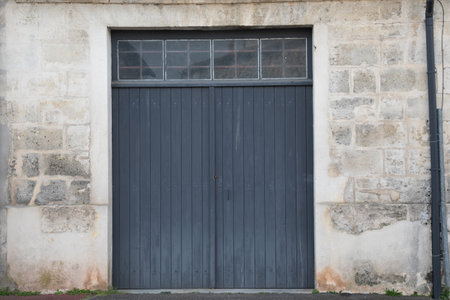 wooden old high door entrance barn gray garage ancient house gray building facadeの写真素材