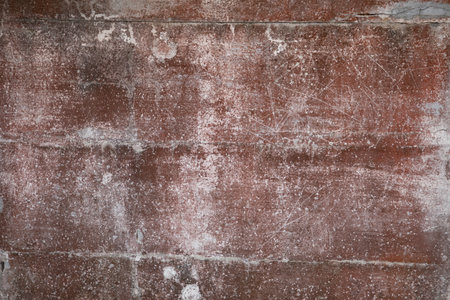 red weathered texture wall concrete white pink background fragment with scratches and cracksの写真素材