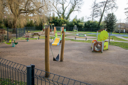 Swings kids outdoor slide colorful playground fun children on yard in the parkの写真素材