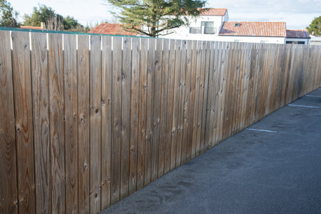 wooden fence on street design wall wooden barrier slats around house protection garden access homeの写真素材