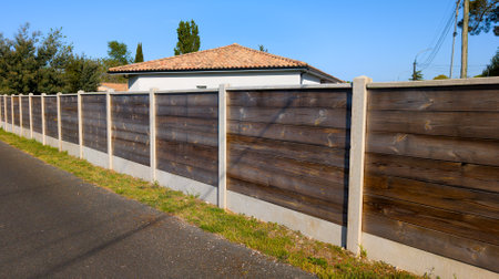 large wood facade palisade long wooden fence to hide the neighbor from house viewの写真素材