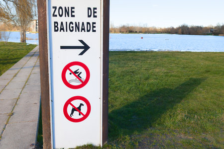 authorized swimming zone area text sign in french means zone de baignade on coast lake forbidden dogの写真素材