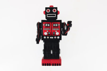 old red and black antique robot toy retro nostalgic figure on white backgroundの写真素材