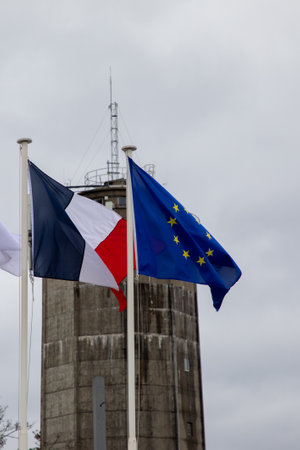 Flags of the European Union and France front building facade French office on gray sky winterの写真素材
