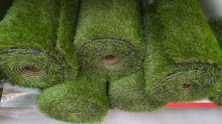 roll of artificial green lawn turf grass in shop for saleの写真素材