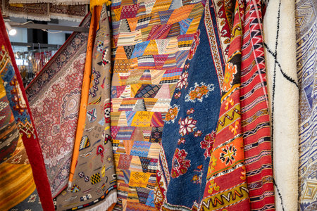 background colorful rugs and carpets in a shop selling typical handicrafts for tourists in the old townの写真素材