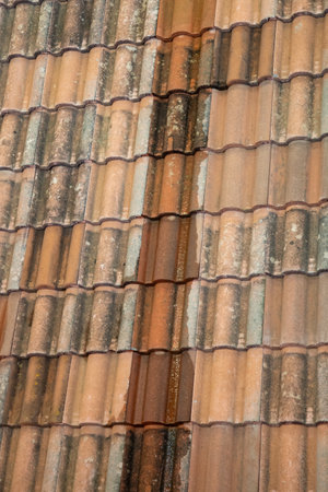 background red and orange roof tiles texture pattern on home roof of house old top buildingの写真素材