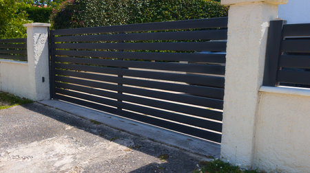gray modern house gate and gray slates garage door to access home gardenの写真素材