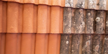 after and before house roof cleaning with high pressure water cleaner tile of homeの写真素材