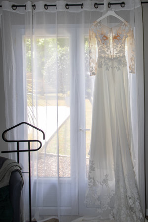 marriage white wedding dress of bride hangs in windows home in celebration dayの写真素材