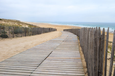 wooden floor pathway access in lacanau ocean beach in west coast sea in southwest Franceの写真素材