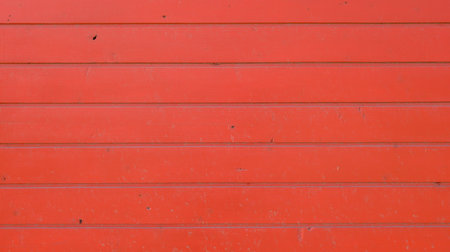 orange wooden wall background red colored wood stripes planks fence wall textureの写真素材