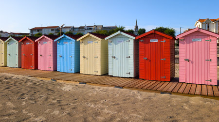 row of colorful wooden beach huts sand beach in atlantic west french coastの写真素材