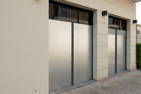industrial metal silver door close on urban storefront exterior with minimalist design and modern architecture for commercial retail business facade entrance outdoorの写真素材