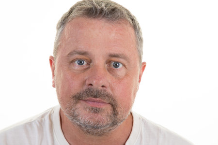 portrait of smiling man handsome blue eye face in white shirt bearded middle aged guy in white...