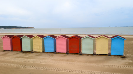 colorfoul beach huts at the beach wooden holiday colorful hut in blue sky and ocean west french coastの写真素材