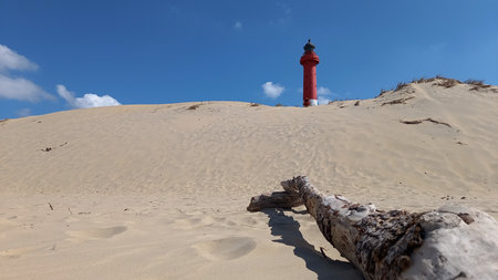 lighthouse La coubre lighthouse on sand beach view in blue sky summer day in west atlantic coast franceの写真素材