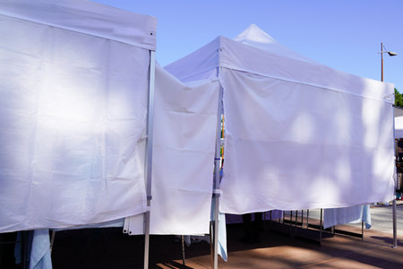 white tent market vendors gazebo stall in behind rear view perfect for commercial use and branding ideal for outdoor markets trade shows and advertisingの写真素材