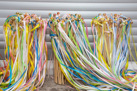 wooden wands with colorful ribbons and bells wedding or celebration send-off wandsの写真素材