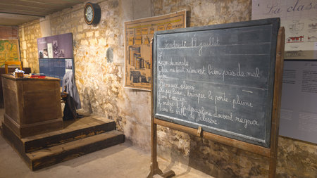 rochefort, france - 11 10 2025: school primary museum old french classroom fifties sixties setting with slate chalkboard teacher desk platformのeditorial素材