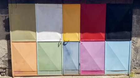 colorful metal doors on a stone wall building portal garageの写真素材