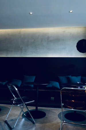 Interior of a hotel lobby with black armchairs and tables.の写真素材