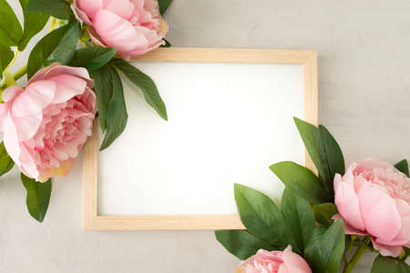 Blank box to write text with pretty peonies and green leaves. Perfect for love messageの写真素材