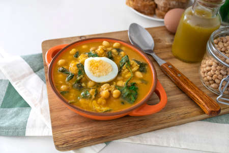 Traditional Spanish cuisine dish that is eaten mainly during the Holy Week holidays. Chickpea, cod, spinach and egg soup. Vigil Pottage.の写真素材