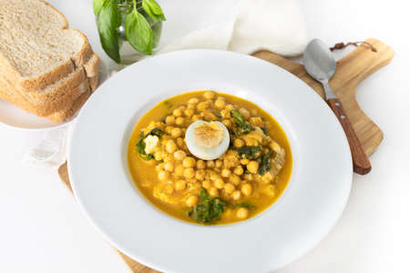 Traditional Spanish cuisine dish that is eaten mainly during the Holy Week holidays. Chickpea, cod, spinach and egg soup. Vigil Pottage.の写真素材