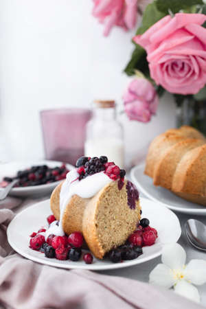 Delicious homemade cake with coconut yogurt cream and red berries. Healthy snack or breakfast....