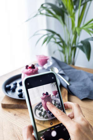 Influencer of cooking recipes taking pictures. Taking photos of a detox shake. Foodie. Lifestyle photographyのeditorial素材
