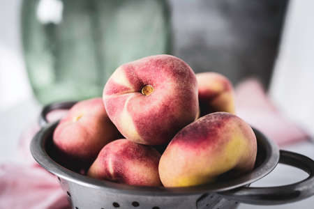 Delicious and fresh flat peaches. Summer fruit. Paraguayan fruit. Still life. Food photographyの写真素材