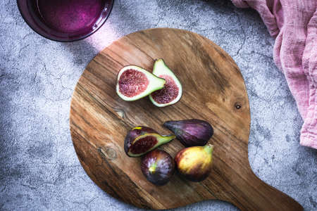 Wooden kitchen board with fresh figs