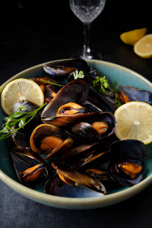 Steamed mussels with herbs and lemon. Tapas plate with mussels. Food photography